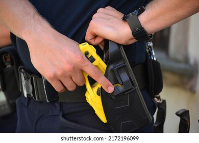 06.24.2022 Wroclaw, Poland, A Policeman On Duty With An Electric Stun Gun. Tazer. Taser