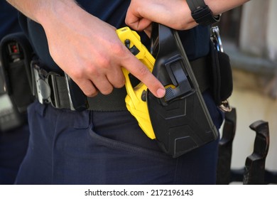 06.24.2022 Wroclaw, Poland, A Policeman On Duty With An Electric Stun Gun. Tazer. Taser