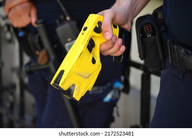 06.24.2022 Wroclaw, Poland, A Policeman On Duty With An Electric Stun Gun. Tazer. Taser