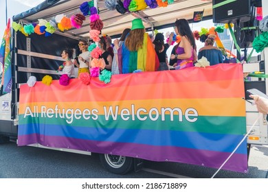 06.25.2022 Warsaw, Poland - All Refugees Welcome. Queer Struggle Concept. Giant Rainbow Flag With A Slogan Placed On A Parade Bus. Equal Human Rights For Everyone. High Quality Photo