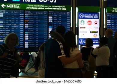 Cancún/Mexico- 06/29/2019: Passengers Monitor Incoming Flights At The Departures Board Inside Cancún International Airport.