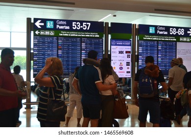 Cancún/Mexico- 06/29/2019: Passengers Monitor Incoming Flights At The Departures Board Inside Cancún International Airport.