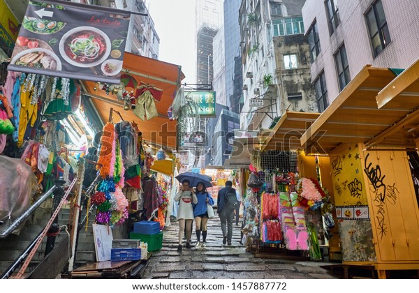 08 03 2019 Hong Kong,\
China - unidentified women walking on a busy market street in the\
afternoon