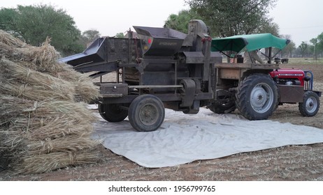 08 April 2021- Akhepura, Sikar, India. Grain Harvester With Thresher Tractor. Tractor With Thresher Machine Closeup In Agriculture Field.