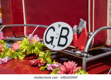 08/11/2019 Portsmouth, Hampshire, UK A Vintage Car Roof Rack With Old Flowers A Suitcase And A GB Sticker