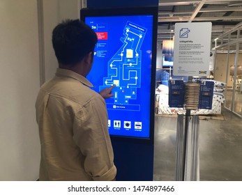 09 Aug 2019; Nonthaburi Thailand: Asian Man Searching At LED Map At IKEA Store And Warehouse Bangyai Thailand.