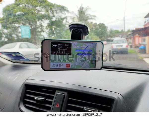 09 January 2021 - KL,\
Malaysia : Mobile phone with map gps navigation in car. Photo of\
Iphone 6 displaying map with route on screen for car driver.\
Selective focus.