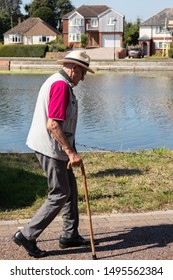 09/02/2019 Emsworth, Hampshire, UK An Elderly Man Taking A Walk Using A Cane Or Walking Stick