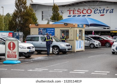 09/16/2019 Havant, Hampshire, UK Attendants Washing Cars At At A Tesco Extra Car Washing Service Area