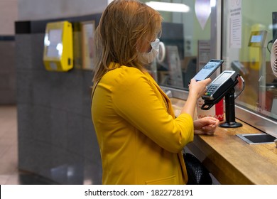 09/25/2020 Russian Federation Moscow. Young Woman In A Disposable Mask Pays For The Moscow Metro Fare With A Smartphone