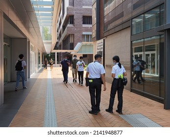 1 10 2021 Man And Woman Security Guards In Uniform With Face Mask Patrol Along Street Among Buildings In University Campus In Hong Kong During Covid-19