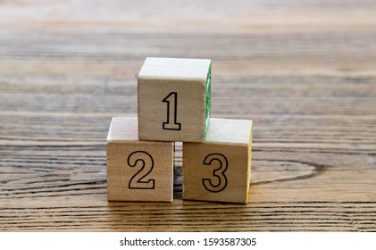 1, 2 And 3 Wooden Blocks On The Table.