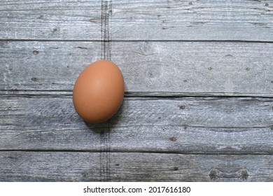 1 Chicken Egg On A Wooden Table.