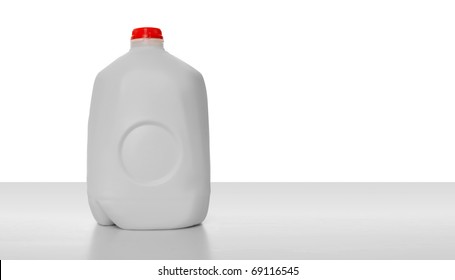 1 Gallon Of Milk In A Milk Carton On A Shiny Table With White Background.