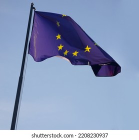 1 One, Alone Flag Of European Union. EU. Wave On Wind. Blue Sky Background. Europa. European Union Flag Blowing On Flag Pole In Wind In Front Clear Blue Sky.