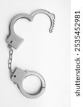 1 one alone Toy grey gray plastic handcuffs. Closed and open handcuffs isolated on white background. cut out. 