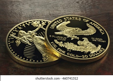 1 Ounce American Gold Eagle Bullion Coins On Wooden Background