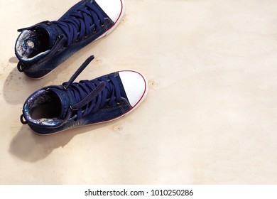 1 Pair Of Blue Sneakers And 1 Bottle Of Water. Placed On A Light Brown Wood Floor. Concept: Sports ,Fitness , Running ,Health  And Exercise. Zumba Dance Workout For Weight Loss.