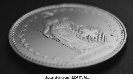 1 Swiss Franc Coin Close-up. Black And White Background Or Wallpaper About Economy, Business Or Swissy. Money And Central Bank In Switzerland. Blurred Figure Of Helvetia, Focus On Cross. Macro