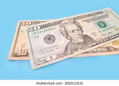 10 and 20 dollars on a blue background. Close-up. - Shutterstock ID 2020113131
