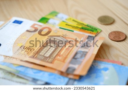 10, 50 euro banknotes, electronic public health insurance cheaper, Insurance Card in German, concept medical support on trip to Europe, guarantee of treatment, payments to medical fund