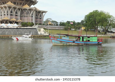 10 April 2021 - Kuching, Sarawak. A C Class Fishing Vessel Passing By A Malaysian Maritime Enforcement Agency MMEA Patrol Boat. Selective Focus