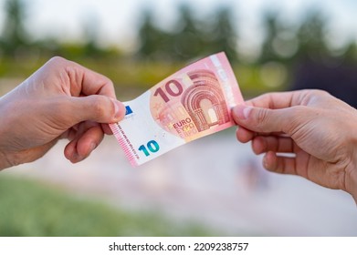 10 Euro Bill Passing From Hand To Hand