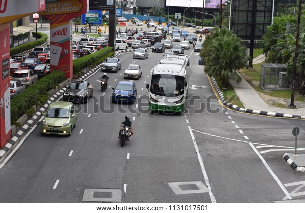 10 july 2018\
afternoon cityscape of a busy street flanked by office towers and\
signs at a dynamic view from a fast moving car at Jalan Bukit\
Bintang at Kuala Lumpur\
Malaysia