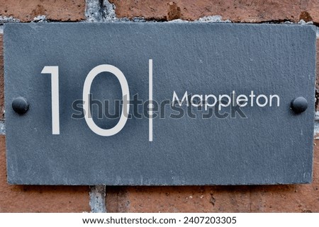 10 mappleton. Welsh slate door numbers and names on a victorian brick wall