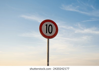 10 miles km maximum speed limit traffic sign isolated with sunset sky - Powered by Shutterstock