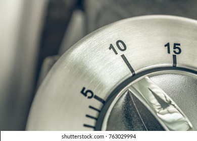 10 Minutes - Macro Of An Analog Chrome Kitchen Timer On Wooden Table
