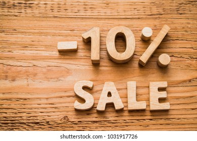 - 10 percent discount icon symbol on a wooden background. Wood sign. Minus ten