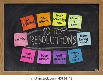 10 Top New Year Resolutions - Colorful Sticky Notes On Blackboard With White Chalk Texture