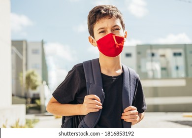 10 Year Old Boy With Backpack Wearing Face Protection Mask Outdoors. Concept Of Back To School During COVID-19 Pandemic.