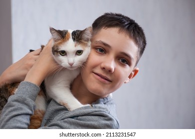 10 Year Old Boy Playing With A Cat