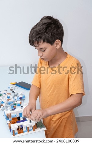 10 year old Brazilian child in pajamas, playing with building blocks_10.