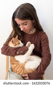 10 Year Old Girl Sleeping In Bed With Her Cat On Top. Horizontal Shot With Natural Light.