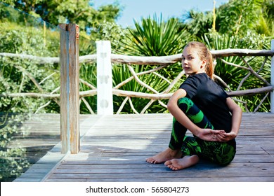 10 Years Old Kid Girl Doing Yoga Asana In The Nature.