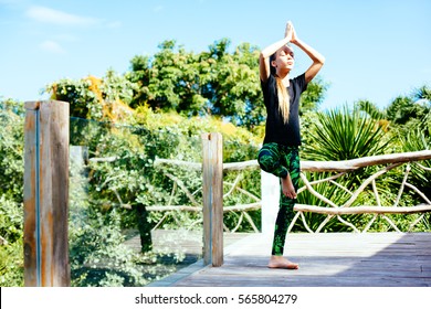 10 Years Old Kid Girl Doing Yoga Asana In The Nature.