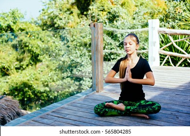 10 Years Old Kid Girl Doing Yoga Asana In The Nature.