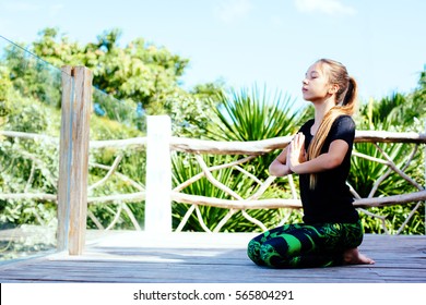 10 Years Old Kid Girl Doing Yoga Asana In The Nature.