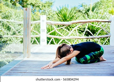 10 Years Old Kid Girl Doing Yoga Asana In The Nature.