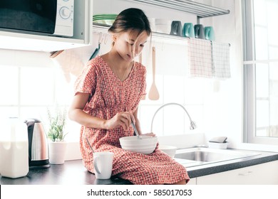 10 Years Old Kid Girl Cooking In The Kitchen, Casual Lifestyle Photo Series. Child Making Breakfast Alone. Cozy Homely Scene.