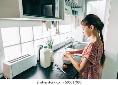 10 Years Old Kid Girl Cooking In The Kitchen, Casual Lifestyle Photo Series. Child Making Breakfast Alone. Cozy Homely Scene.