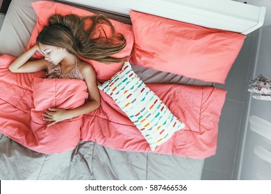 10 Years Old Pre Teen Kid Girl Sleeping In The Bed With Pink Bedding, Top View