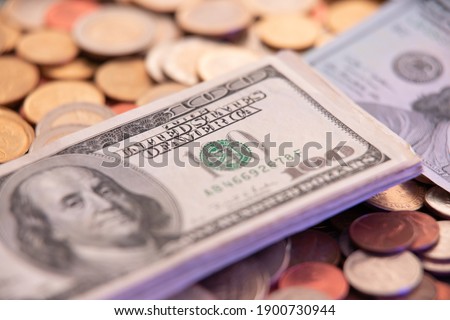 100 Dollar Bills on top of coins. USA Currency. Fiat Currency of the United States of America Treasury Department