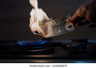 100 Euro Banknote Burns On The Fire Of A Gas Burner, Expensive LNG Gas, Energy Transition To ESG