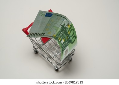 100 (hundred) euros for shopping, in a shopping cart on white background. High quality photo