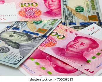 100 Renminbi And American Dollar Banknotes.