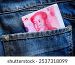 a 100 renminbi Chinese note was in a jeans pocket. a 100 yuan note. Chinese currency